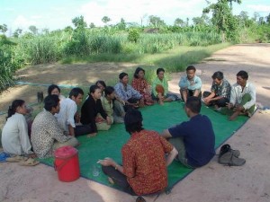 Bernie meeting with farmers in rural village in Cambodia